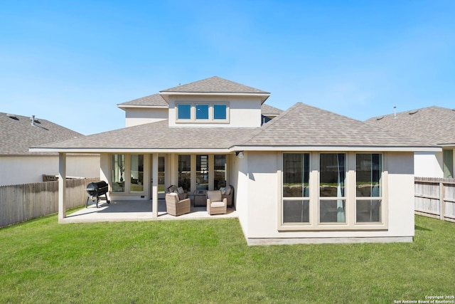 back of property with a patio area, a lawn, and a fenced backyard