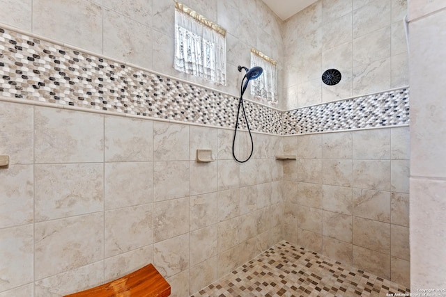 bathroom with tiled shower