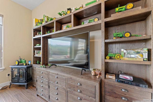 interior space with baseboards and wood finished floors