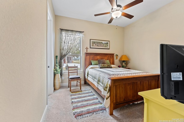 bedroom with light carpet, baseboards, and a ceiling fan