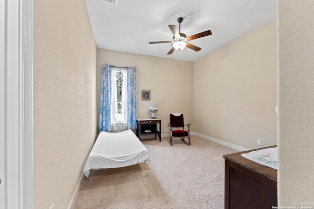 sitting room with light carpet, visible vents, a ceiling fan, and baseboards