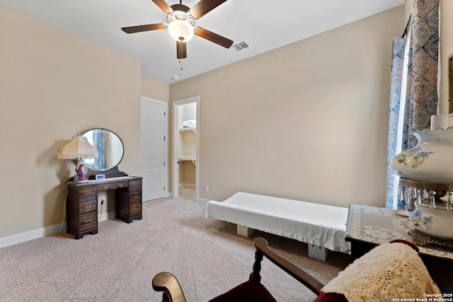 interior space with baseboards, visible vents, ceiling fan, and light colored carpet