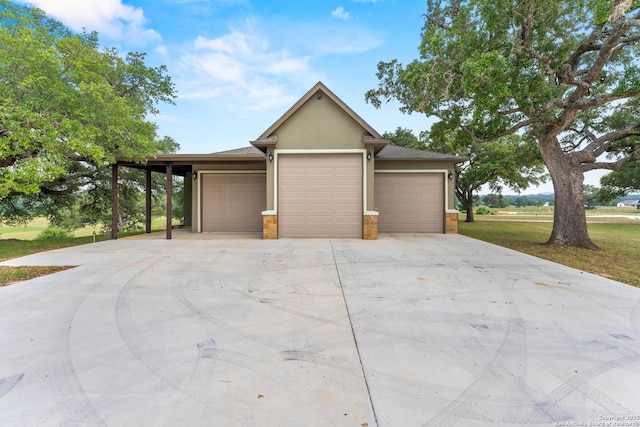 garage featuring concrete driveway