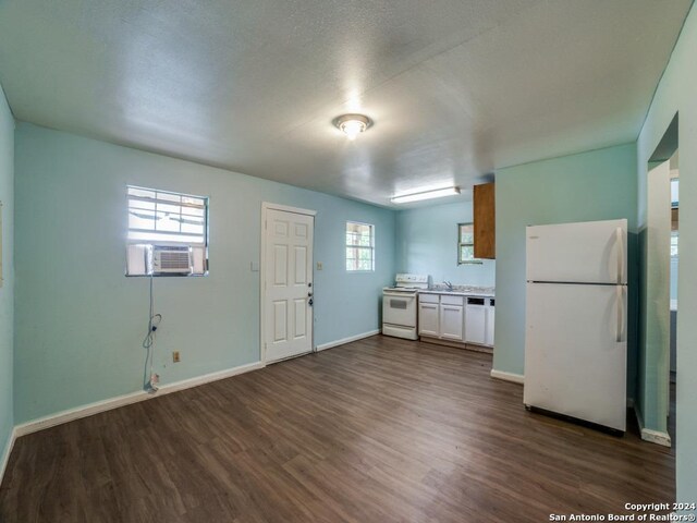 3315 Pitluk Ave, San Antonio, TX 78211 - kitchen with light countertops, white appliances, dark wood-style flooring, and white cabinetry