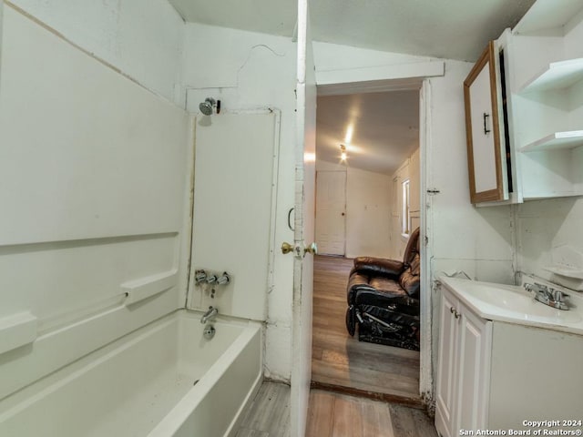 3315 Pitluk Ave, San Antonio, TX 78211 - bathroom featuring lofted ceiling, bathtub / shower combination, wood finished floors, and vanity