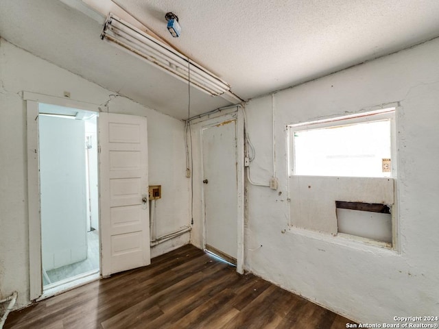 3315 Pitluk Ave, San Antonio, TX 78211 - empty room with lofted ceiling, dark wood finished floors, and a textured ceiling