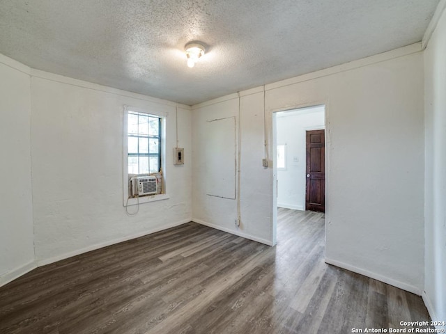 3315 Pitluk Ave, San Antonio, TX 78211 - spare room featuring baseboards, a textured ceiling, cooling unit, and dark wood-type flooring