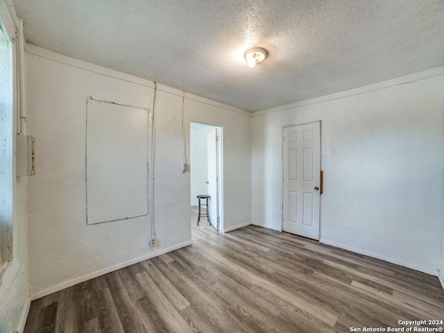 3315 Pitluk Ave, San Antonio, TX 78211 - empty room with a textured ceiling, baseboards, and wood finished floors