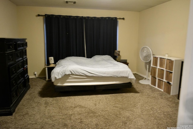 bedroom featuring dark colored carpet, visible vents, and baseboards