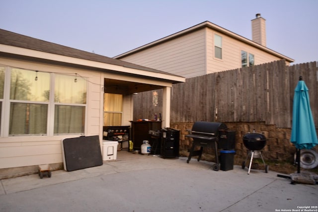 patio terrace at dusk with fence and grilling area