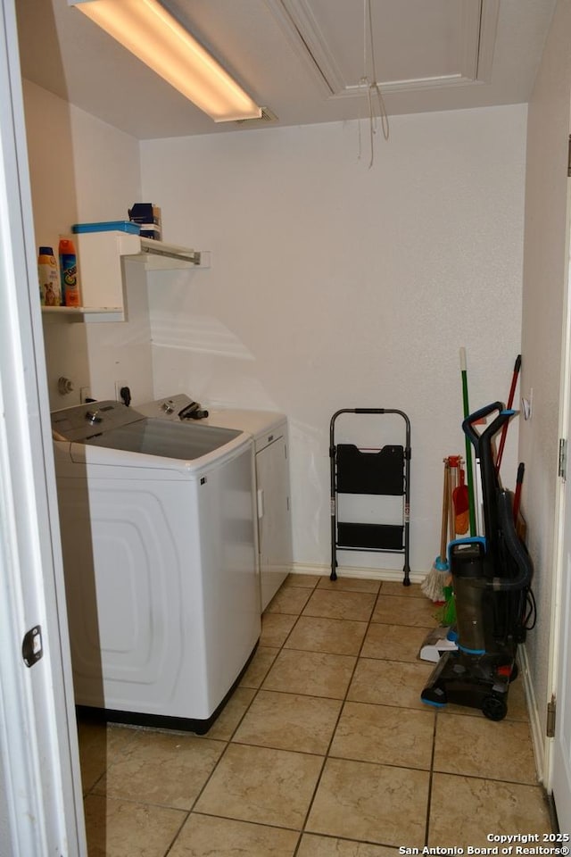 laundry room with attic access, laundry area, washer and clothes dryer, and light tile patterned floors