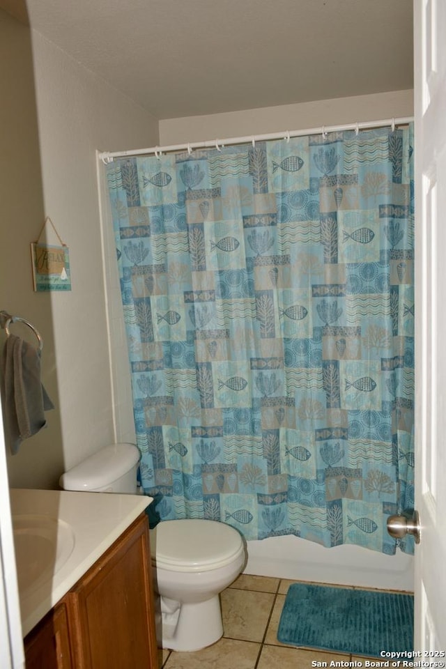 bathroom featuring shower / tub combo with curtain, vanity, toilet, and tile patterned floors