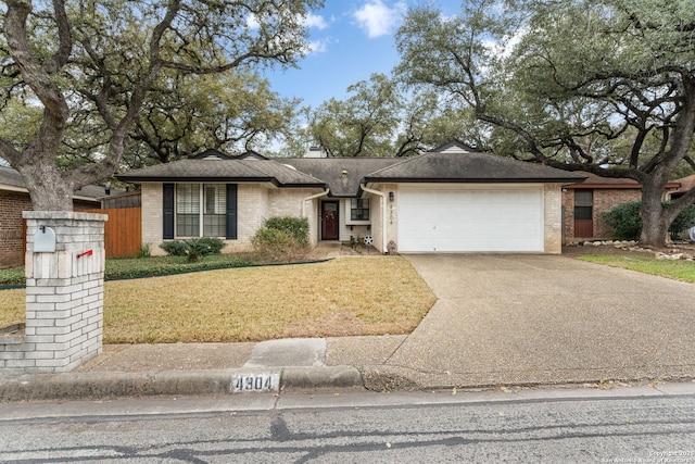 view of front of home with a garage, brick siding, a shingled roof, concrete driveway, and a front yard