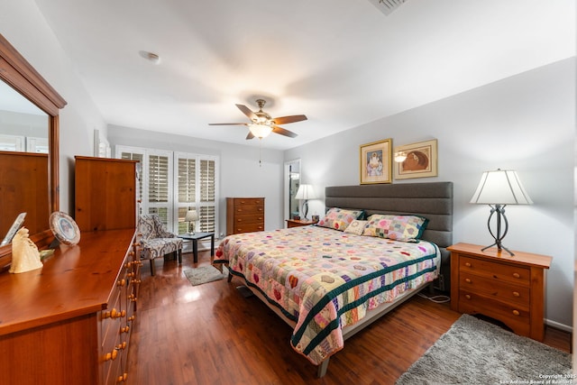 bedroom with dark wood-style flooring, visible vents, and ceiling fan