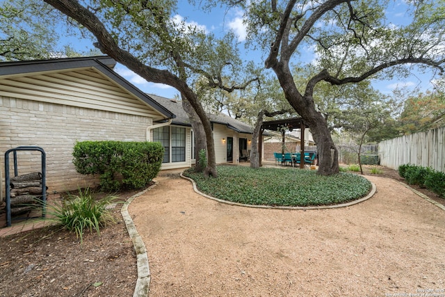 view of yard with a patio and fence