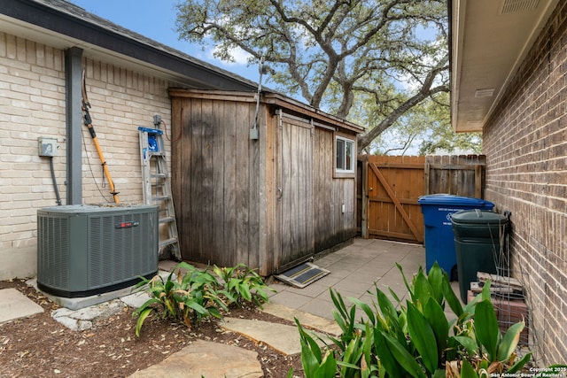 view of patio with central air condition unit, a gate, and fence