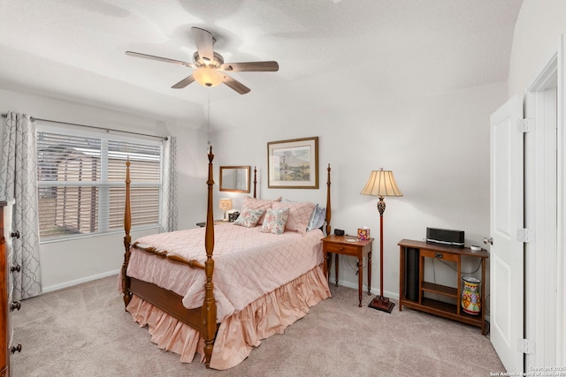 bedroom featuring a ceiling fan, light colored carpet, and baseboards