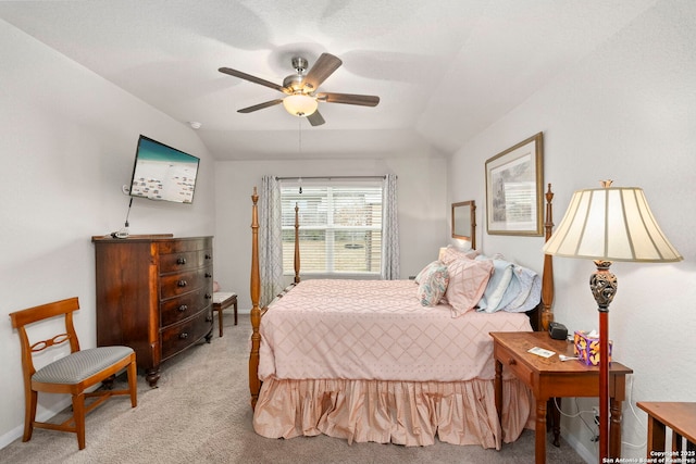 bedroom featuring a ceiling fan, light carpet, vaulted ceiling, and baseboards