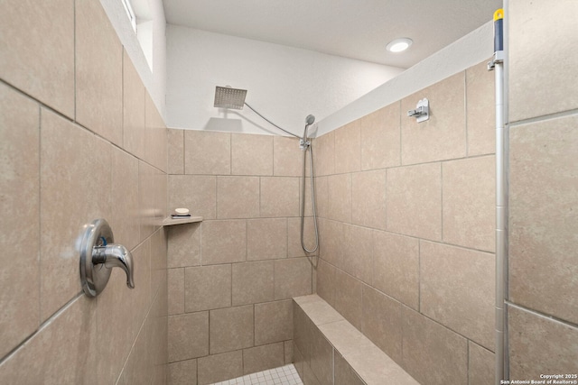 bathroom with tiled shower