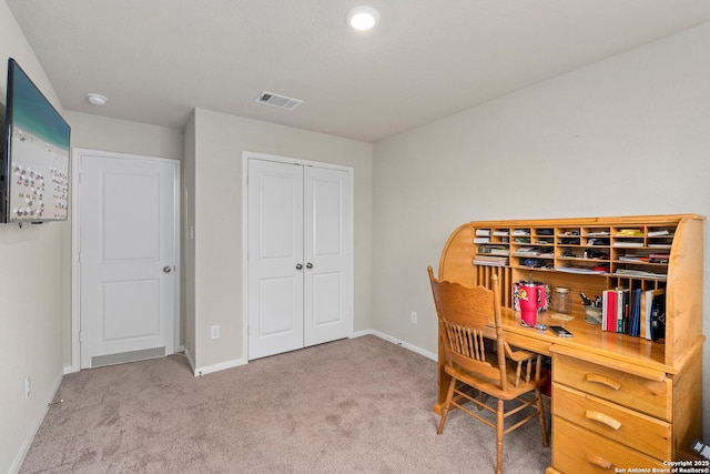 home office with light carpet, visible vents, and baseboards