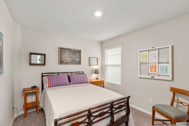 carpeted bedroom featuring baseboards