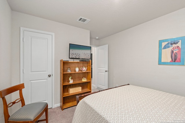 bedroom featuring baseboards, visible vents, and light colored carpet