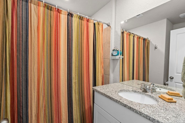 full bath featuring curtained shower and vanity