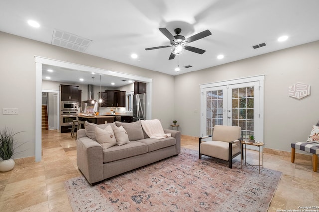 living area with recessed lighting, baseboards, visible vents, and french doors