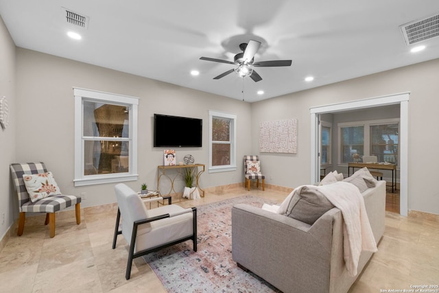 living area featuring recessed lighting and visible vents