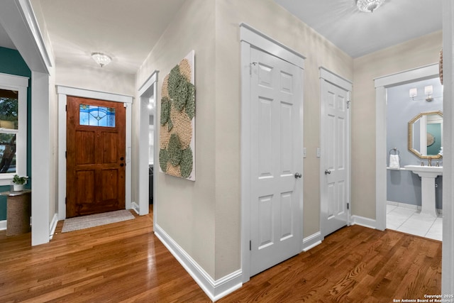 entrance foyer featuring wood finished floors and baseboards