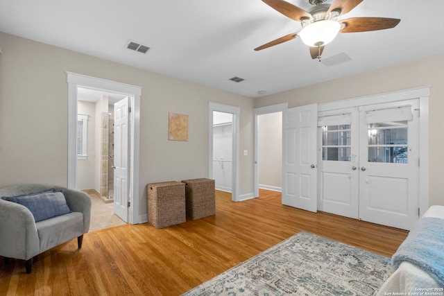 sitting room with baseboards, visible vents, wood finished floors, and french doors