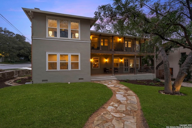 back of property with crawl space, a balcony, a patio, and a yard