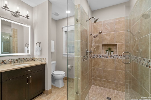 bathroom featuring a stall shower, tasteful backsplash, visible vents, toilet, and vanity