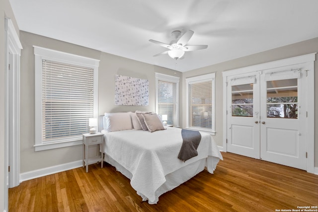 bedroom with a ceiling fan, baseboards, and wood finished floors