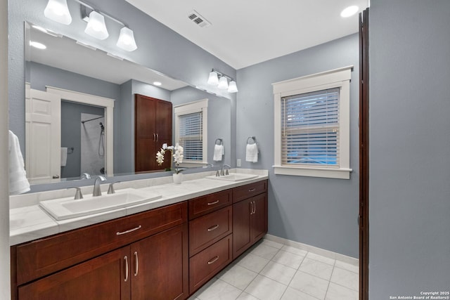 bathroom featuring double vanity, tile patterned flooring, a sink, and visible vents