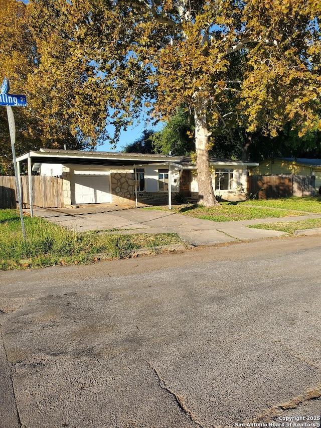 view of front of home featuring stone siding and fence