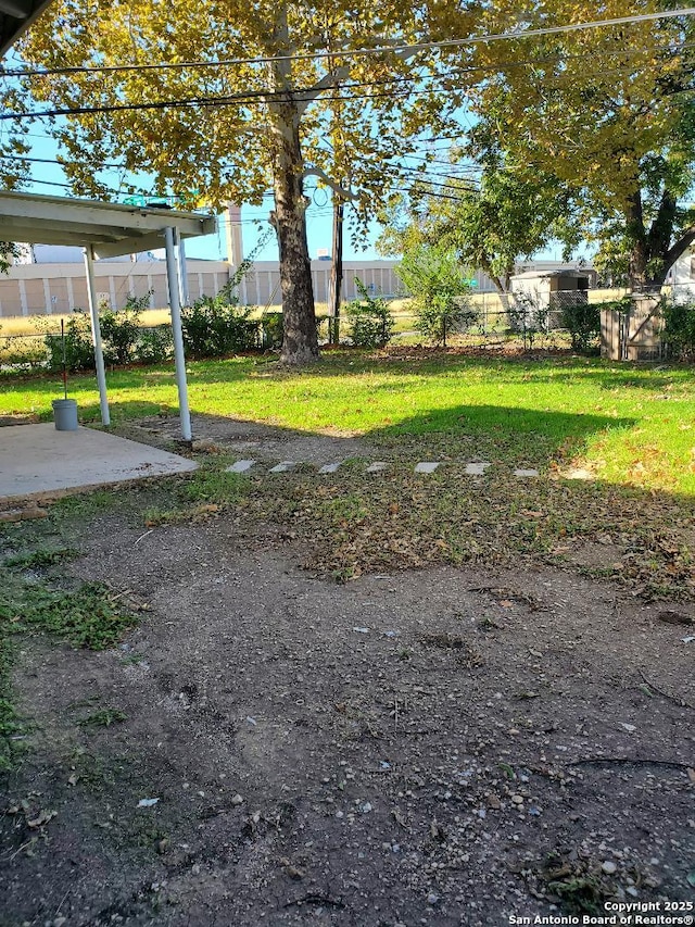 view of yard with fence and a patio