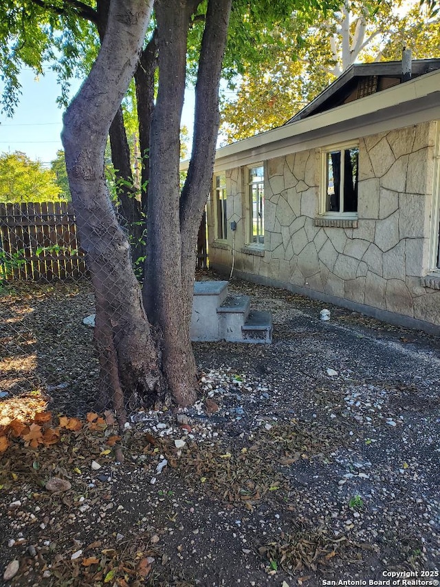 view of home's exterior with fence