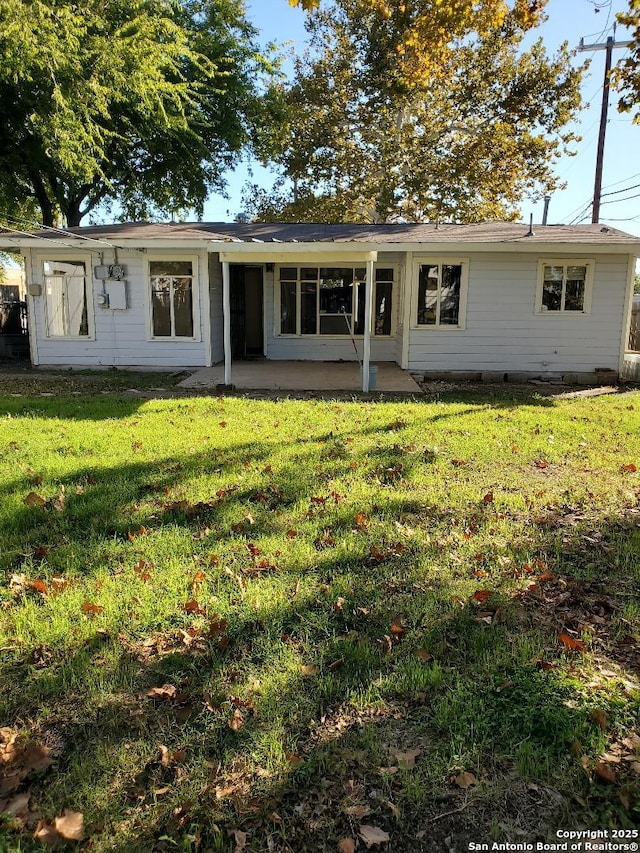 view of front of property with a patio and a front yard