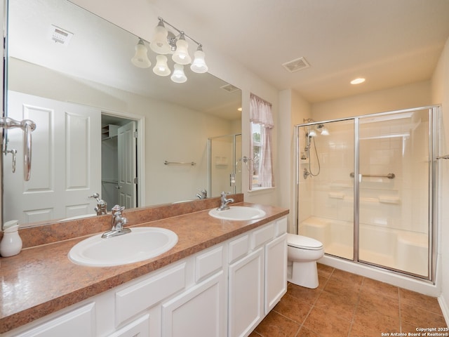 bathroom with a stall shower, tile patterned flooring, visible vents, and a sink