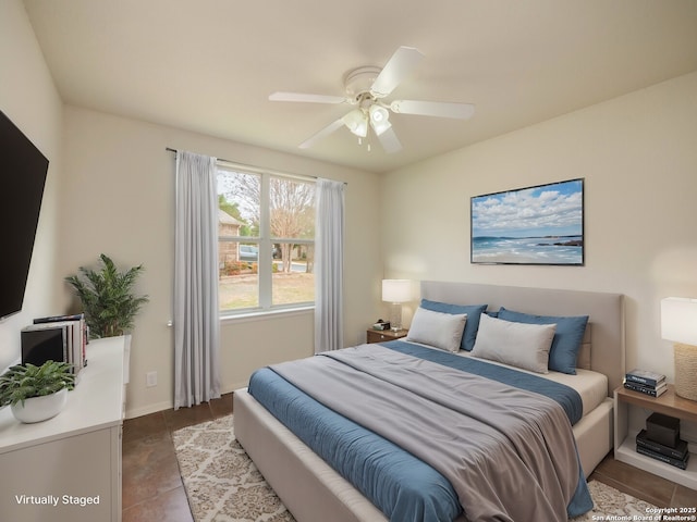 tiled bedroom with ceiling fan and baseboards