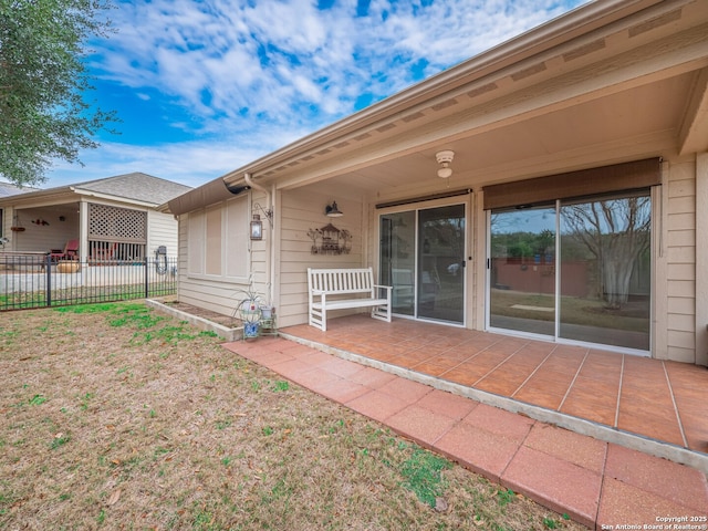 property entrance featuring a patio and fence