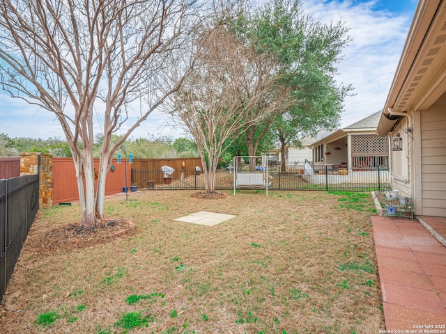 view of yard with an outbuilding, a storage unit, and a fenced backyard