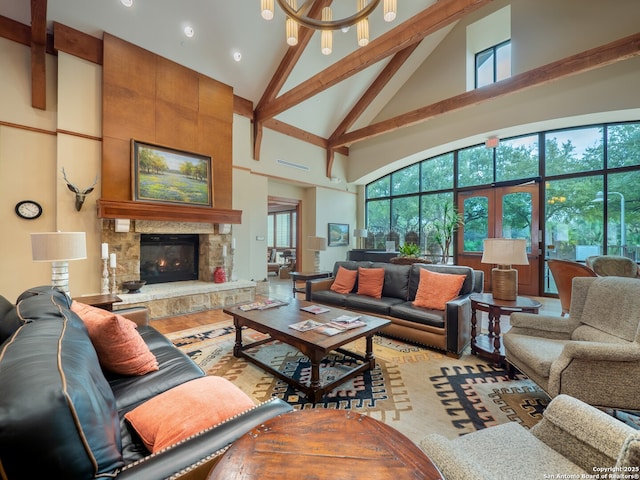 living room featuring high vaulted ceiling, beamed ceiling, and a stone fireplace