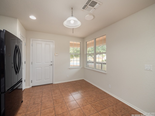 kitchen with baseboards, visible vents, freestanding refrigerator, pendant lighting, and light tile patterned flooring