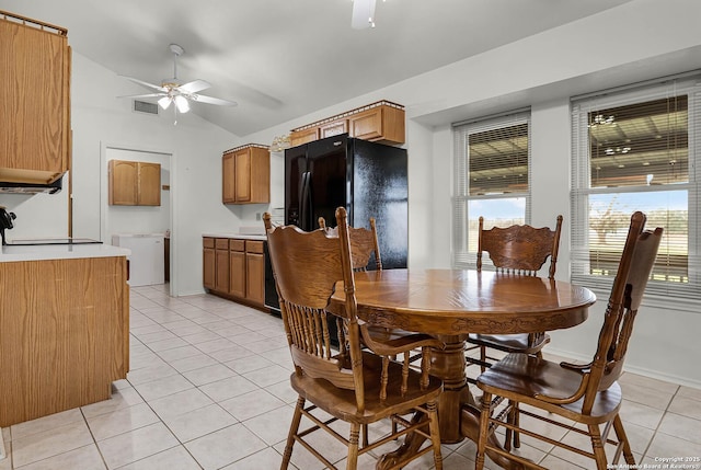 dining space featuring light tile patterned floors, ceiling fan, lofted ceiling, visible vents, and baseboards