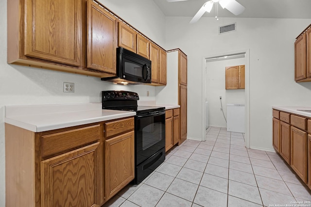 kitchen featuring visible vents, brown cabinetry, light countertops, black appliances, and light tile patterned flooring