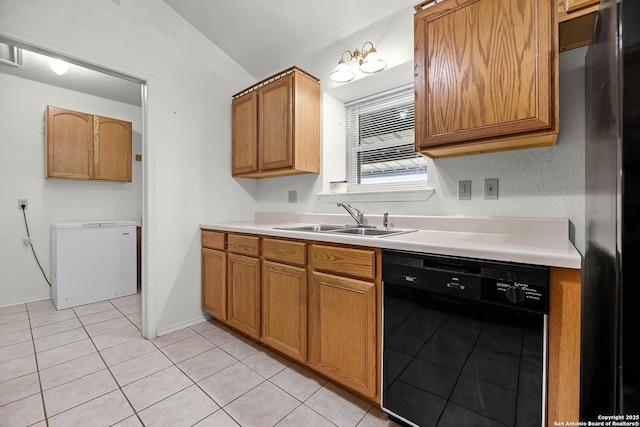 kitchen featuring light tile patterned floors, brown cabinets, light countertops, black appliances, and a sink