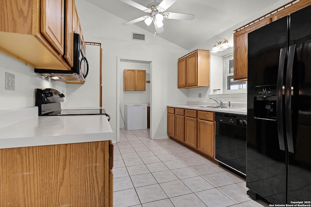 kitchen with brown cabinets, light tile patterned floors, lofted ceiling, light countertops, and black appliances