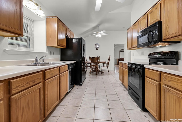 kitchen with a ceiling fan, brown cabinets, light countertops, black appliances, and a sink